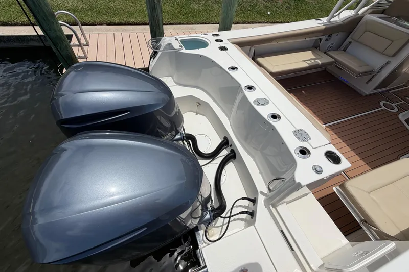 Slide: The Image of 2018 Sailfish 325 DC boat with dual outboard engines and spacious deck seating. - 8
