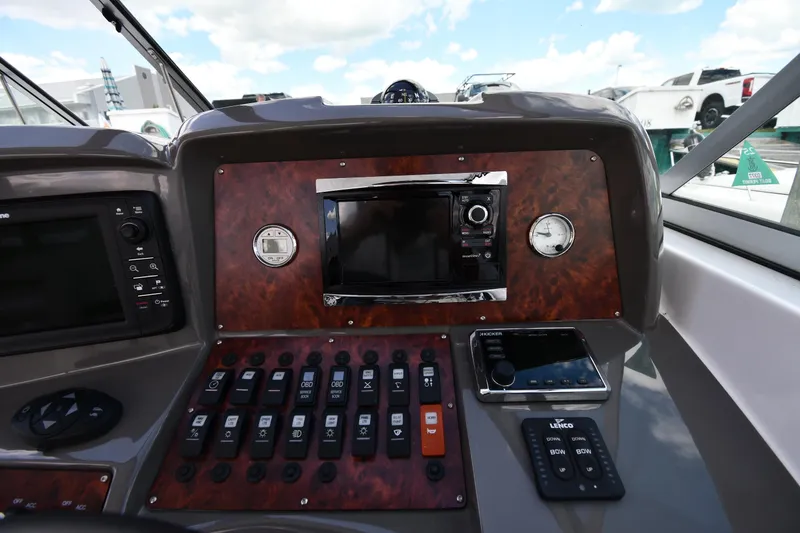 Slide: The Image of 2017 Rinker EX 320 boat dashboard with control panel and navigation instruments. - 15
