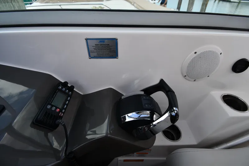 Slide: The Image of 2017 Rinker EX 320 boat dashboard with controls and speaker. - 16
