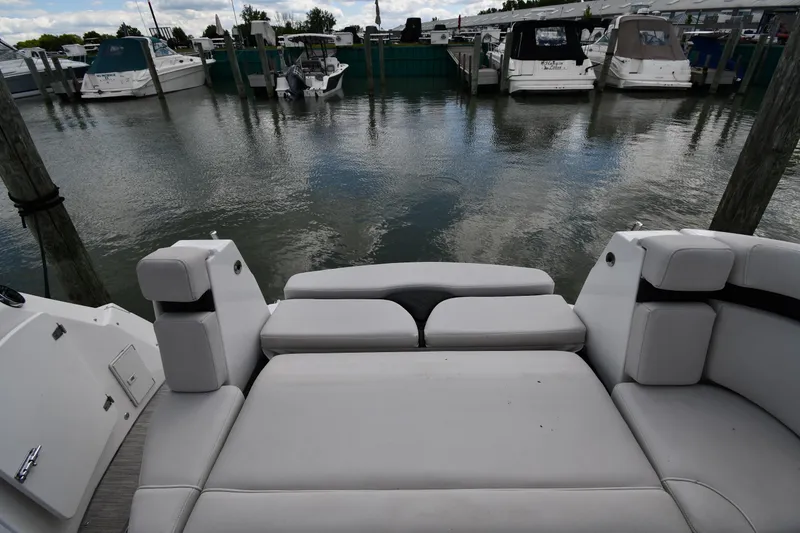 Slide: The Image of 2017 Rinker EX 320 boat interior with marina view in the background. - 22