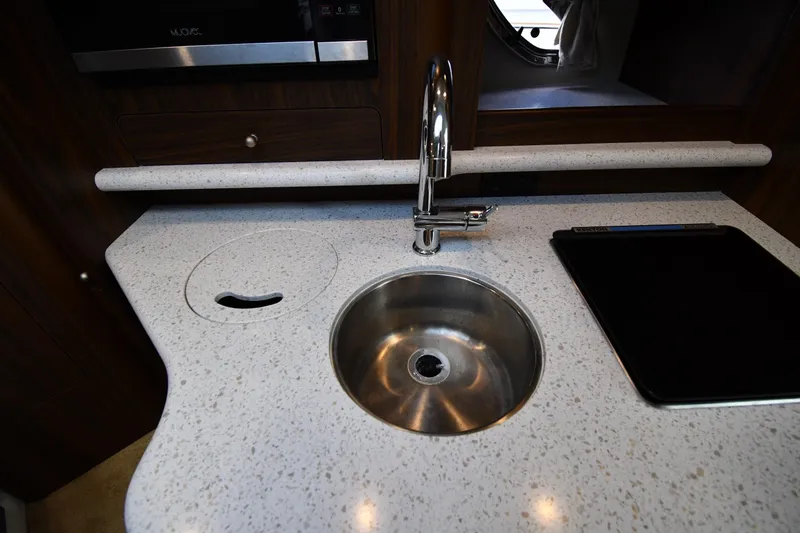 Slide: The Image of 2017 Rinker EX 320 boat kitchen with modern sink and countertop. - 30