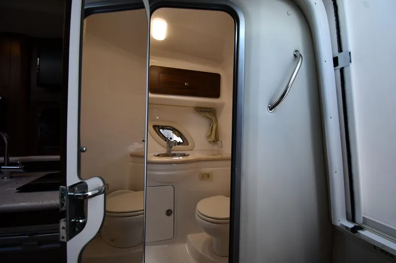 Slide: The Image of 2017 Rinker EX 320 boat bathroom interior with sink and toilet. - 34