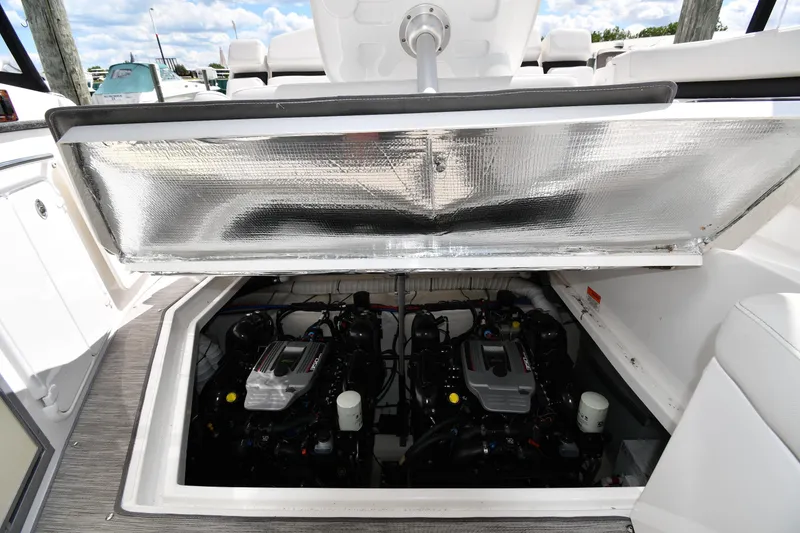 Slide: The Image of 2017 Rinker EX 320 boat engine compartment with dual engines visible. - 39