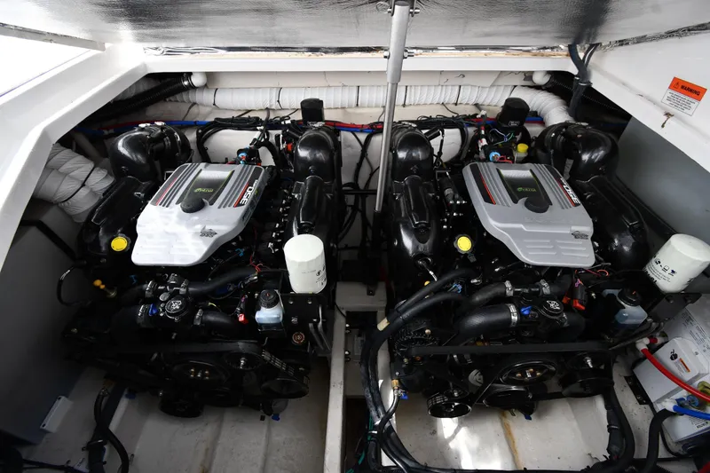 Slide: The Image of 2017 Rinker EX 320 boat engine compartment with dual engines. - 40