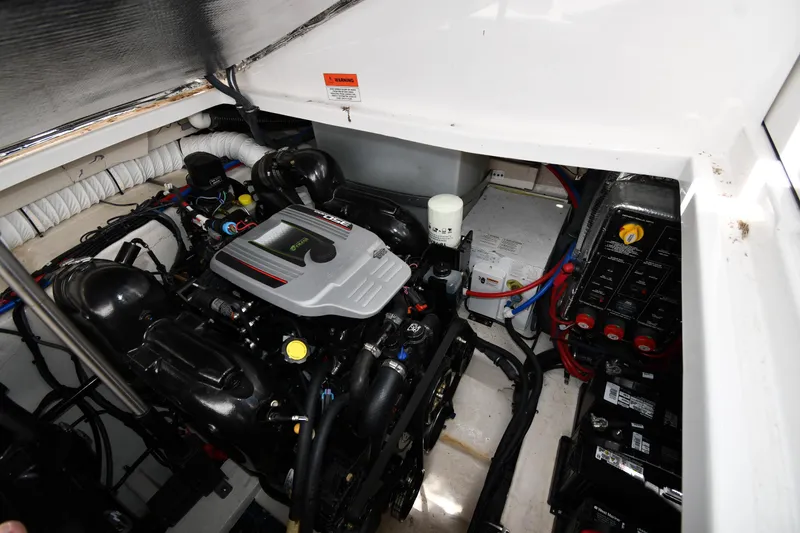 Slide: The Image of Engine compartment of a 2017 Rinker EX 320 boat, showcasing mechanical components. - 41