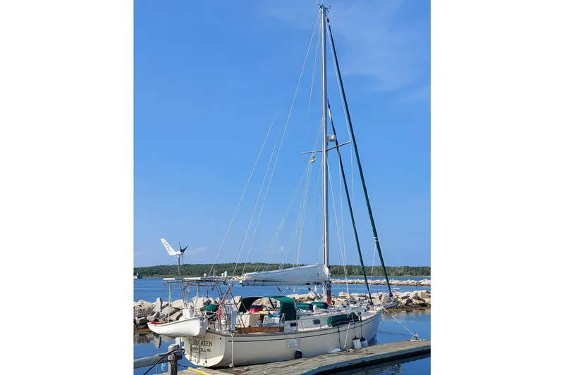 Slide: The Image of Sailboat docked at marina, Island Packet 38, 1990 model, under clear blue sky. - 1