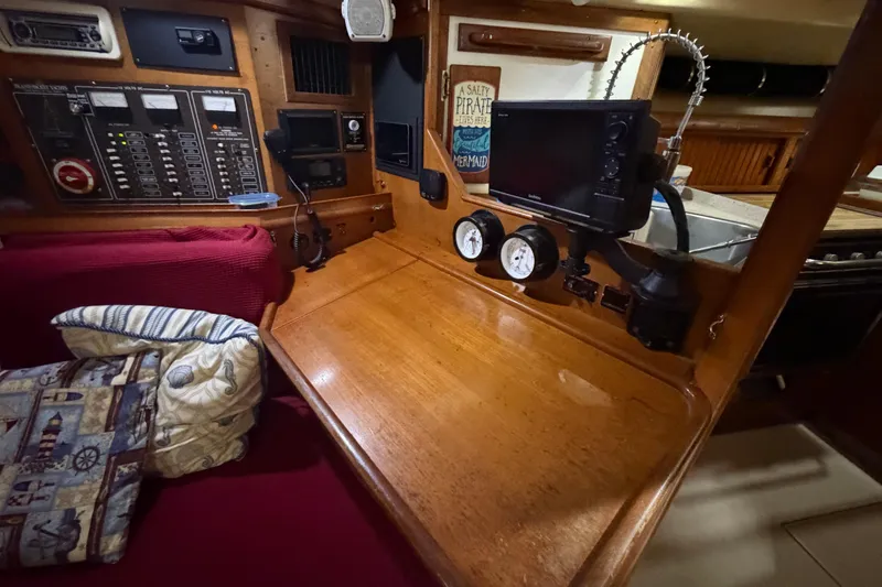 Slide: The Image of Navigation station of a 1990 Island Packet 38 sailboat with control panels and gauges. - 12