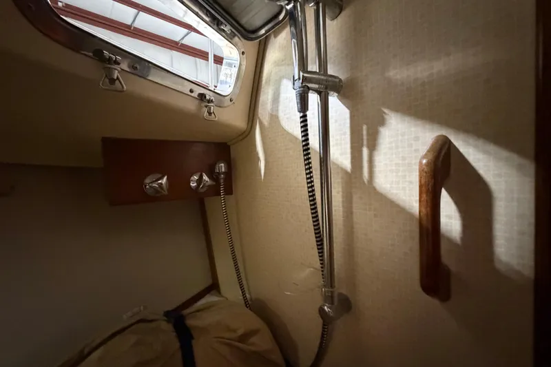 Slide: The Image of Interior of 1990 Island Packet 38 sailboat shower area with window and fixtures. - 20