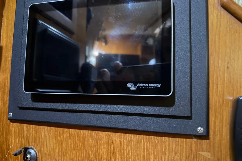 Slide: The Image of Victron Energy display on 1990 Island Packet 38 sailboat interior. - 25