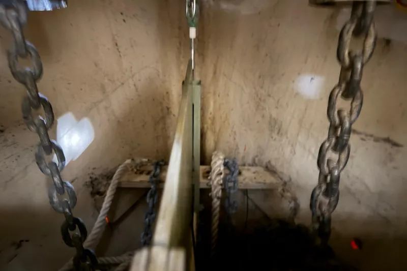 Slide: The Image of Interior view of a 1990 Island Packet 38 sailboat's anchor locker with chains and ropes. - 32