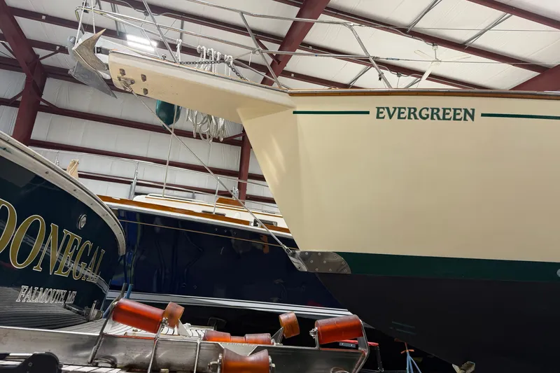 Slide: The Image of 1990 Island Packet 38 sailboat "Evergreen" in indoor storage, showcasing its bow and anchor. - 34