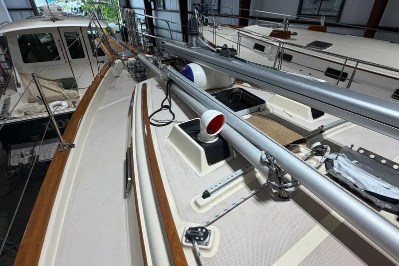 Slide: The Image of 1990 Island Packet 38 sailboat deck with rigging and equipment in a marina. - 39