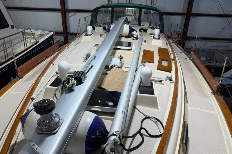 Slide: The Image of 1990 Island Packet 38 sailboat deck with rigging and equipment in a marina. - 41