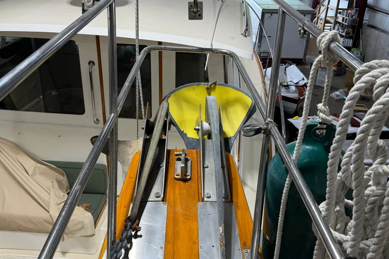 Slide: The Image of 1990 Island Packet 38 sailboat deck with anchor and ropes in storage. - 42
