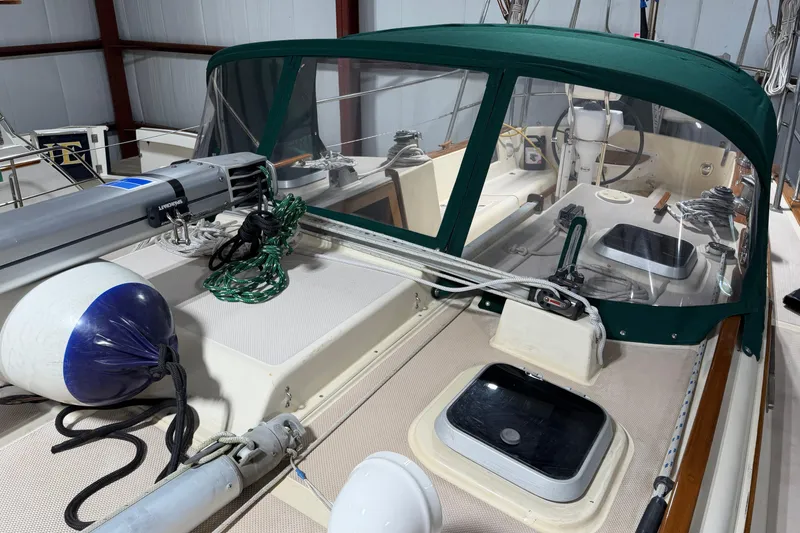 Slide: The Image of 1990 Island Packet 38 sailboat deck with green canopy and nautical equipment. - 43