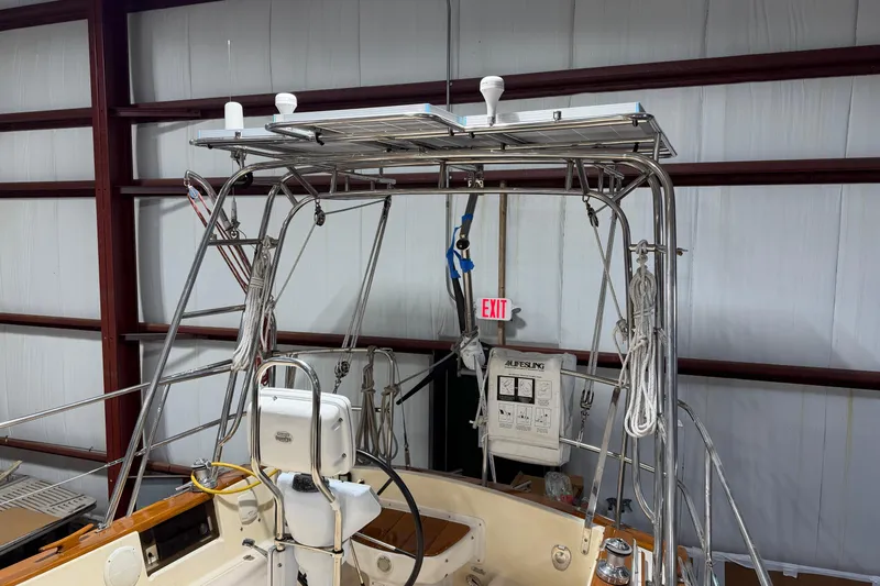 Slide: The Image of 1990 Island Packet 38 sailboat interior with navigation equipment and safety gear in storage. - 44