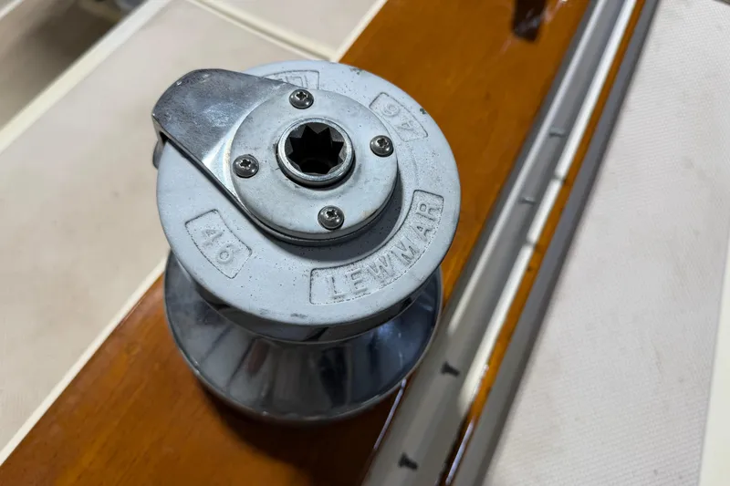 Slide: The Image of Lewmar winch on 1990 Island Packet 38 sailboat, mounted on polished wood surface. - 45