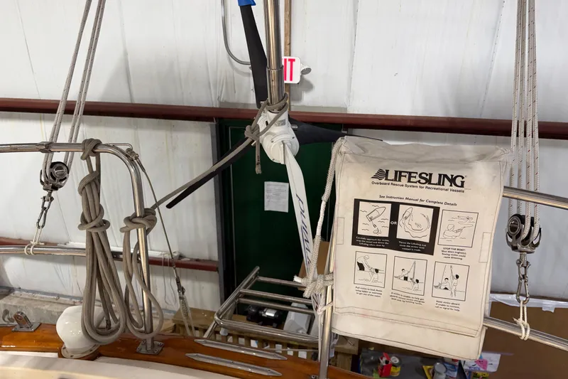 Slide: The Image of Lifesling rescue system on 1990 Island Packet 38 sailboat, featuring ropes and pulleys. - 46