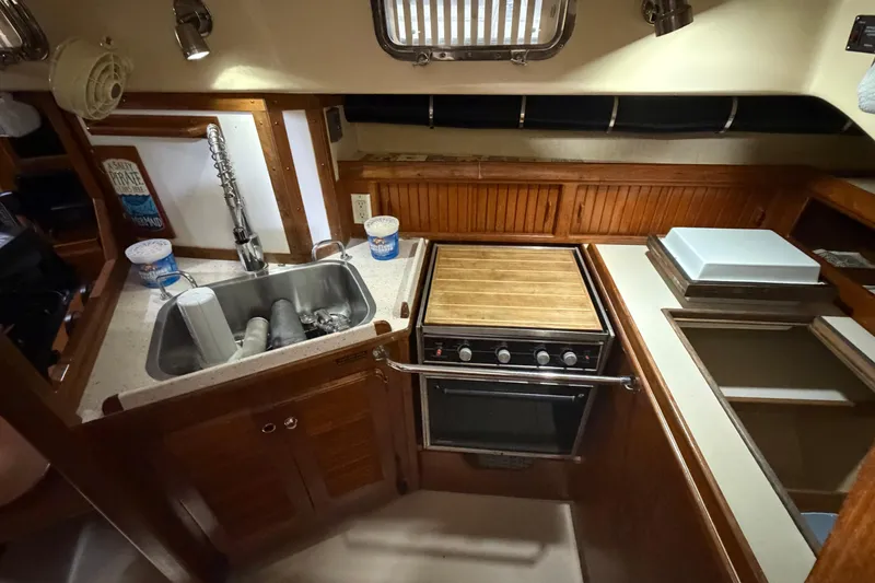 Slide: The Image of Interior of a 1990 Island Packet 38 sailboat kitchen with sink and stove. - 8