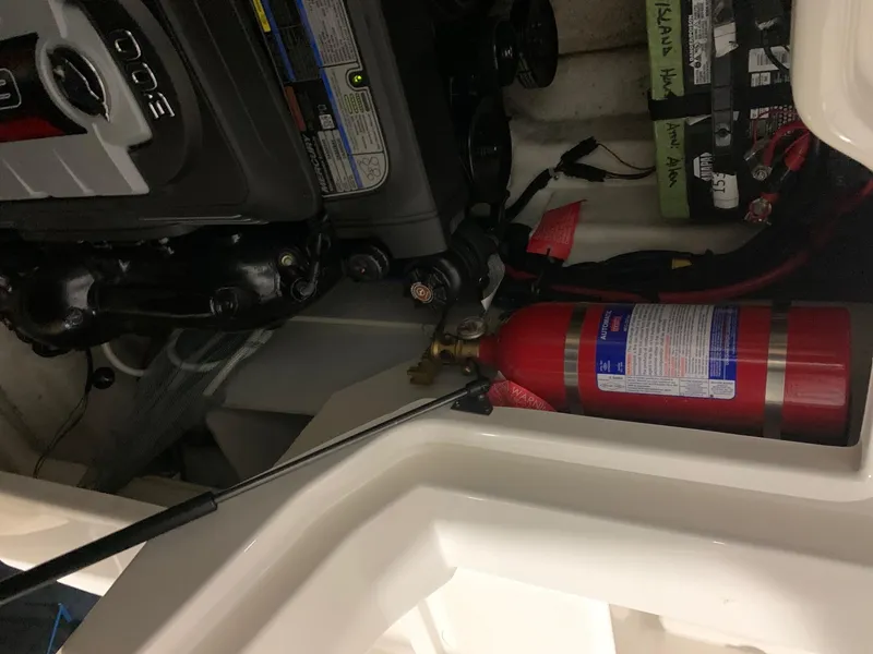 Slide: The Image of An engine compartment with a fire extinguisher and an engine. - 28