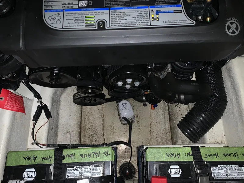 Slide: The Image of Engine compartment of a Sea Ray 240 Sundeck boat with batteries and hoses. - 30