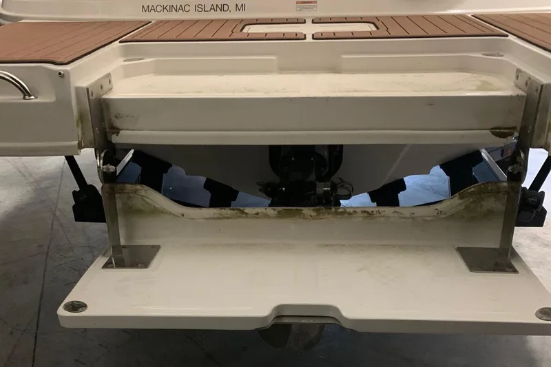Slide: The Image of The image shows the stern of a Sea Ray 240 Sundeck boat with a swim platform. - 32