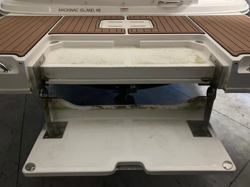 Slide: The Image of The image shows the stern of a Sea Ray 240 Sundeck boat with a swim platform. - 33