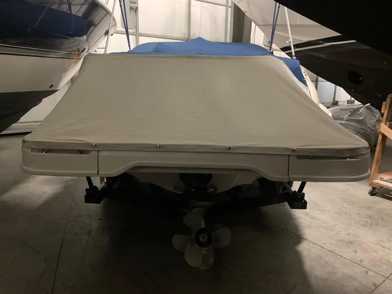 Slide: The Image of A covered boat in a storage facility, with a visible propeller underneath. - 34