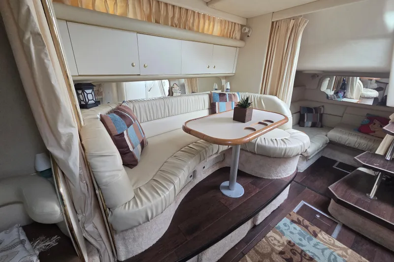 Slide: The Image of Luxurious interior of a 1999 Sea Ray 340 Sundancer yacht with plush seating and elegant decor. - 14