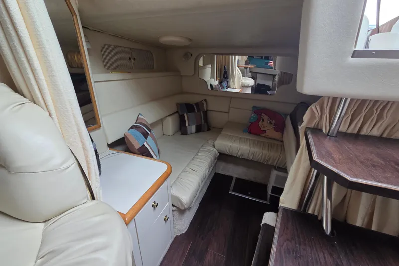 Slide: The Image of Interior of 1999 Sea Ray 340 Sundancer yacht with cozy seating and decorative pillows. - 15