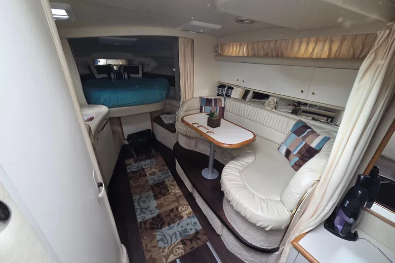 Slide: The Image of Interior of 1999 Sea Ray 340 Sundancer yacht with cozy seating and sleeping area. - 17