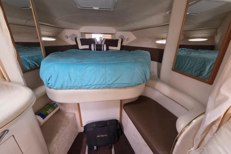 Slide: The Image of Interior cabin of 1999 Sea Ray 340 Sundancer with blue bedding and mirrors. - 18