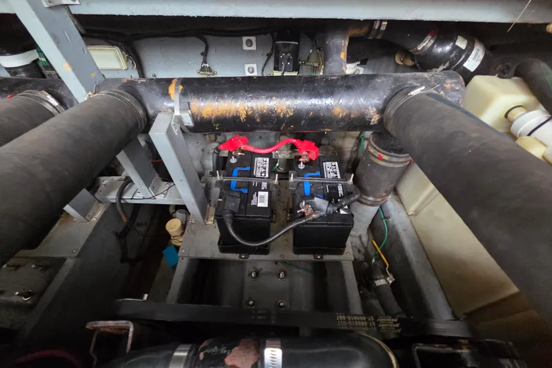 Slide: The Image of Engine compartment of a 1999 Sea Ray 340 Sundancer with visible battery and wiring. - 22