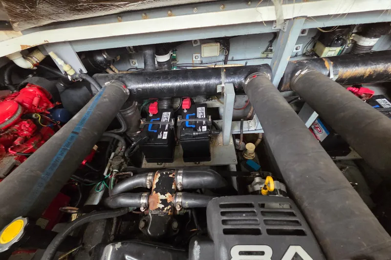 Slide: The Image of Engine compartment of a 1999 Sea Ray 340 Sundancer with visible batteries and components. - 23