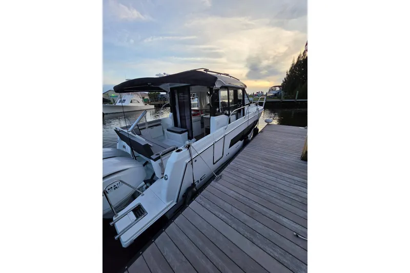Slide: The Image of 2026 Jeanneau NC 895 Series 2 docked at sunset, showcasing sleek design and modern features. - 1
