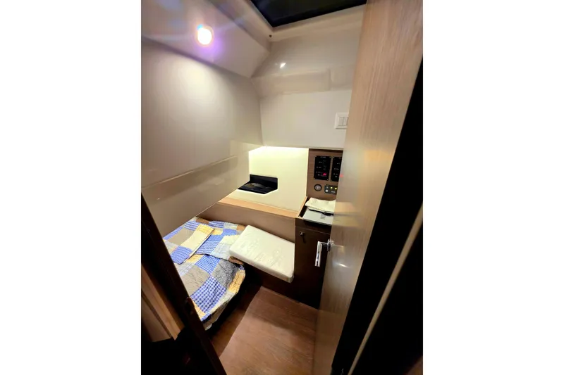 Slide: The Image of Interior cabin of 2026 Jeanneau NC 895 Series 2, featuring cozy bed and control panel. - 11