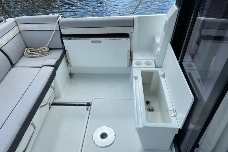 Slide: The Image of 2026 Jeanneau NC 895 Series 2 boat deck with seating and storage compartments. - 12