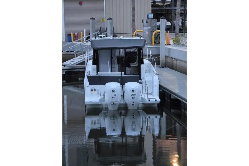 Slide: The Image of 2026 Jeanneau NC 895 Series 2 boat docked with twin outboard engines. - 3