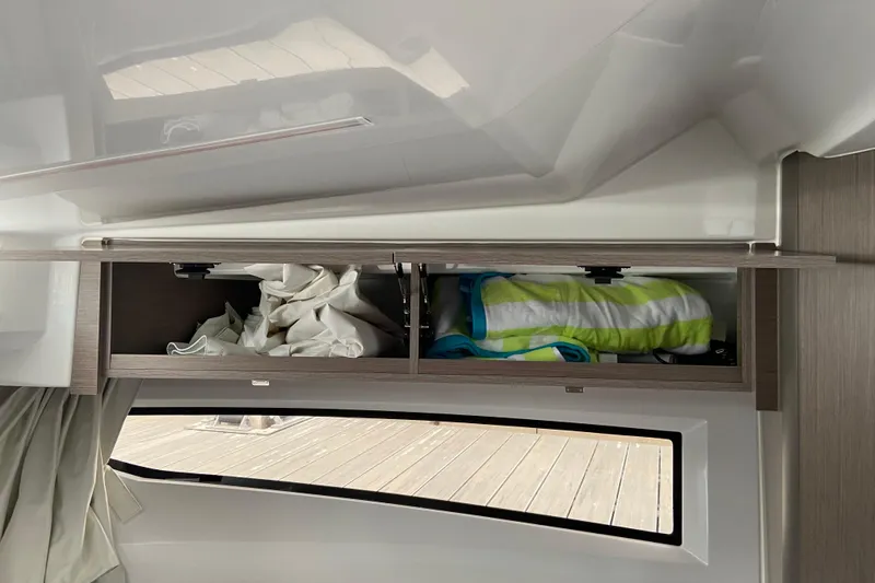 Slide: The Image of Interior storage of 2026 Jeanneau NC 895 Series 2 boat with open cabinet. - 47