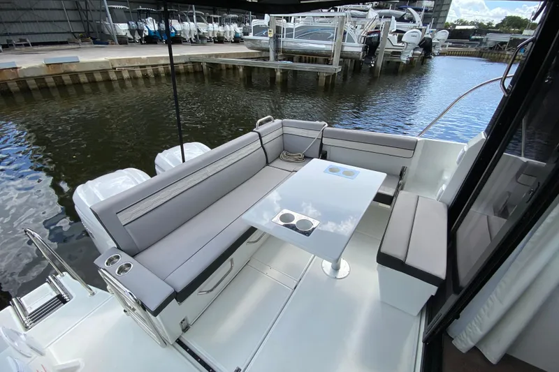 Slide: The Image of 2026 Jeanneau NC 895 Series 2 boat with sleek seating and table on deck. - 10