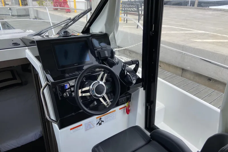 Slide: The Image of Interior helm of 2026 Jeanneau NC 895 Series 2 boat with modern controls and steering wheel. - 18
