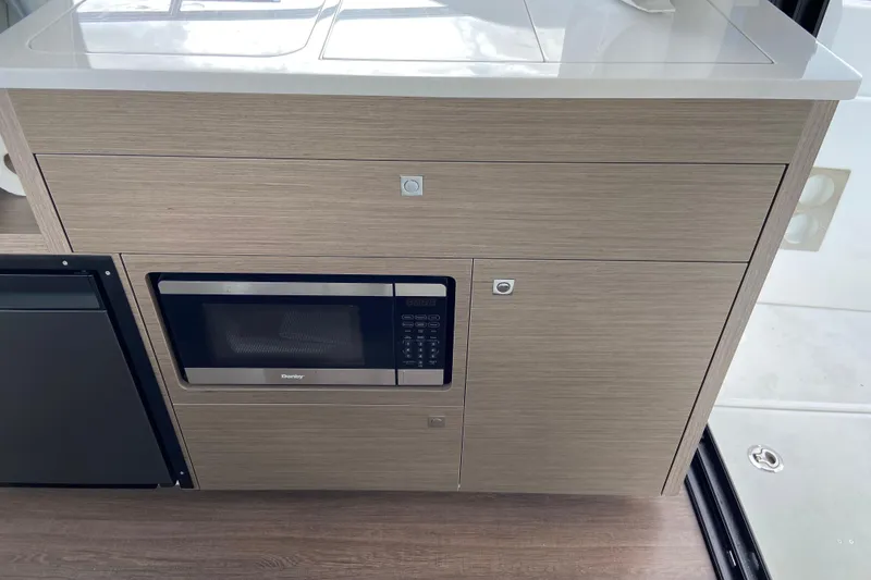 Slide: The Image of Modern kitchen area in 2026 Jeanneau NC 895 Series 2 boat with microwave. - 30