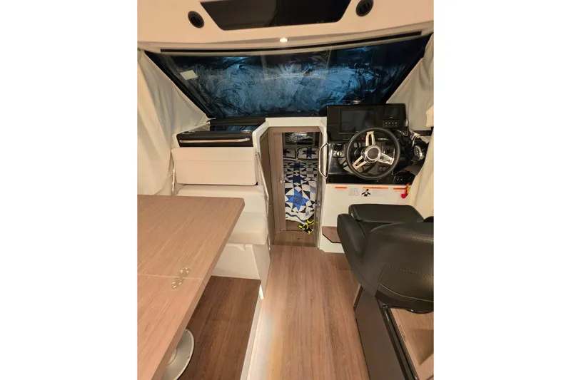 Slide: The Image of Interior of 2026 Jeanneau NC 895 Series 2 boat, featuring helm and seating area. - 6