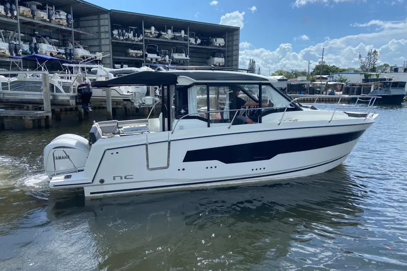Slide: The Image of 2026 Jeanneau NC 895 Series 2 boat on water, docked near marina. - 7