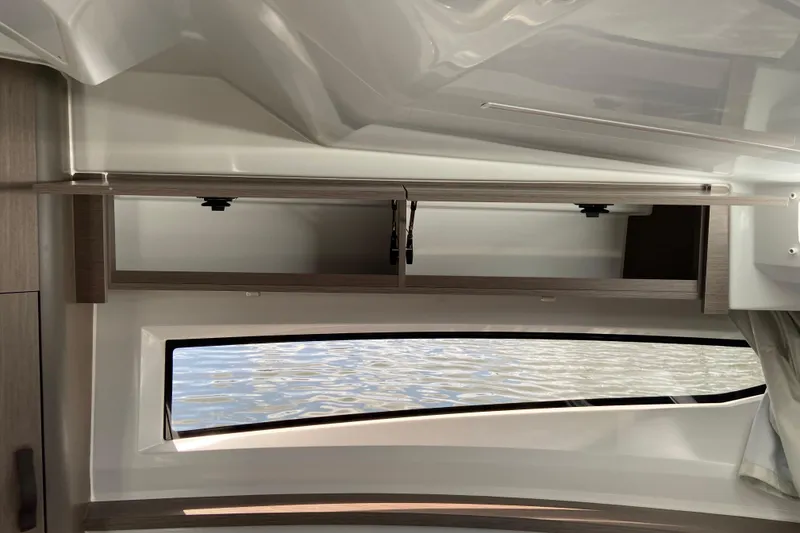 Slide: The Image of Interior view of 2026 Jeanneau NC 895 Series 2 boat with window and storage. - 45