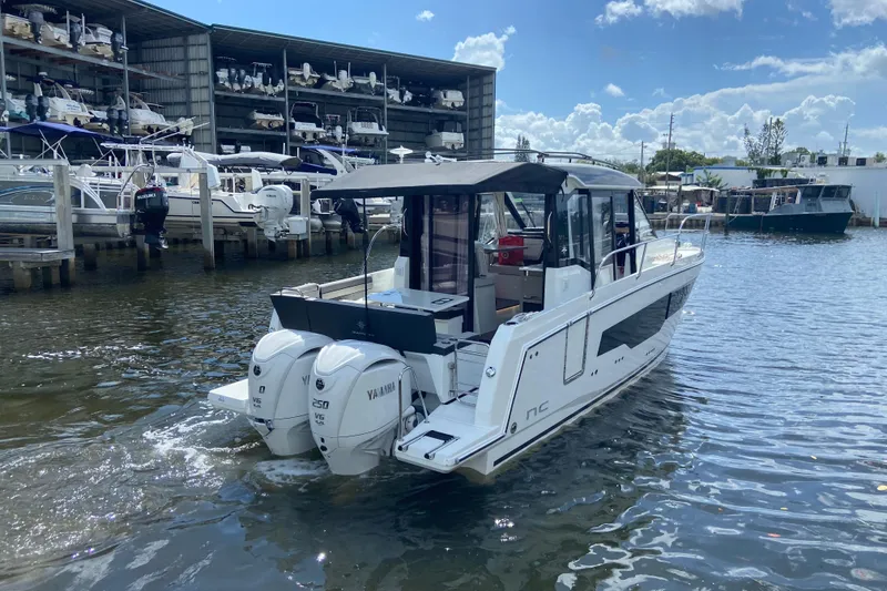 Slide: The Image of 2026 Jeanneau NC 895 Series 2 boat with twin Yamaha engines in a marina setting. - 6
