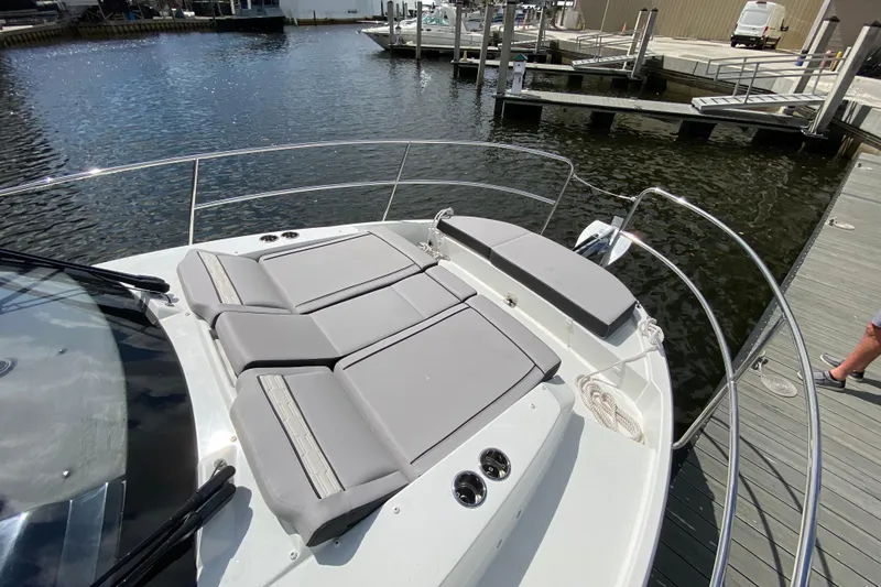 Slide: The Image of 2026 Jeanneau NC 895 Series 2 boat with sunbathing area, docked at marina. - 62