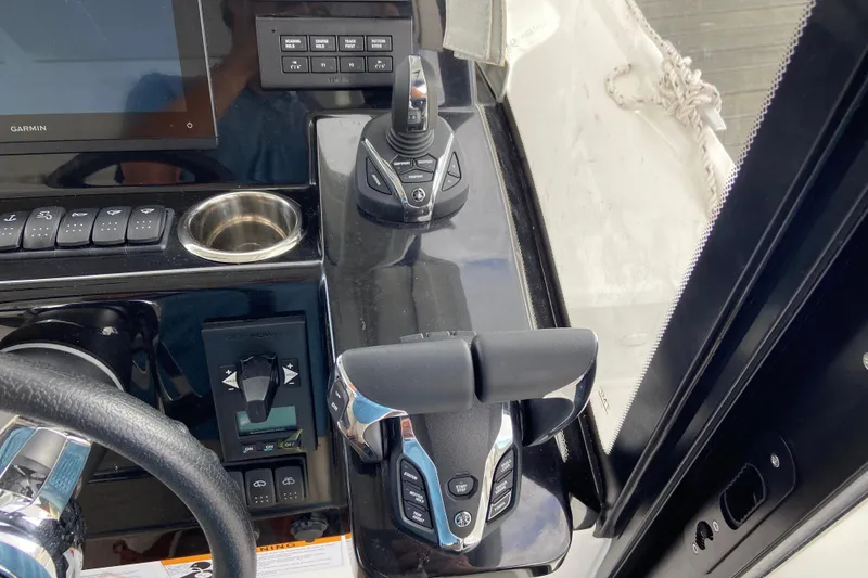 Slide: The Image of Control panel of 2026 Jeanneau NC 895 Series 2 boat with joystick and throttle. - 21