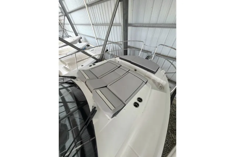 Slide: The Image of 2026 Jeanneau NC 895 Series 2 boat with cushioned deck in a storage facility. - 9