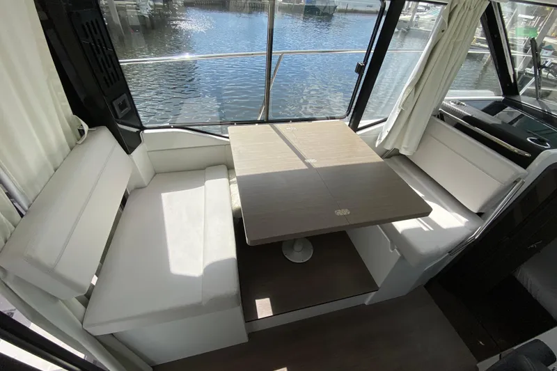 Slide: The Image of Interior of 2026 Jeanneau NC 895 Series 2 boat with dining area and waterfront view. - 15